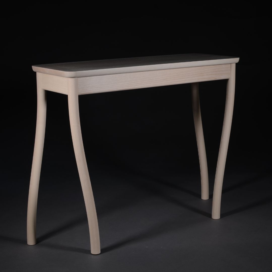 walking-table-square-4 Light wood console table with curved legs against a dark background, no items on top, showcasing the table's design.